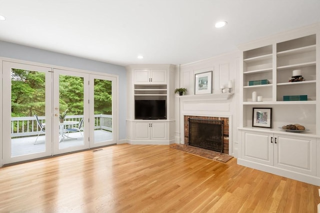 7 Cider Hill Ln, Sherborn, MA 01770 - unfurnished living room with light wood-type flooring, a fireplace, recessed lighting, and built in features