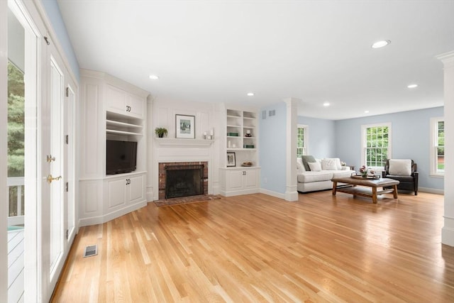 7 Cider Hill Ln, Sherborn, MA 01770 - living room featuring light wood-type flooring, a brick fireplace, baseboards, recessed lighting, and built in features
