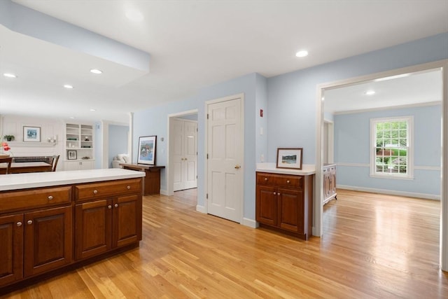 7 Cider Hill Ln, Sherborn, MA 01770 - kitchen featuring light wood-type flooring, light countertops, recessed lighting, baseboards, and brown cabinets