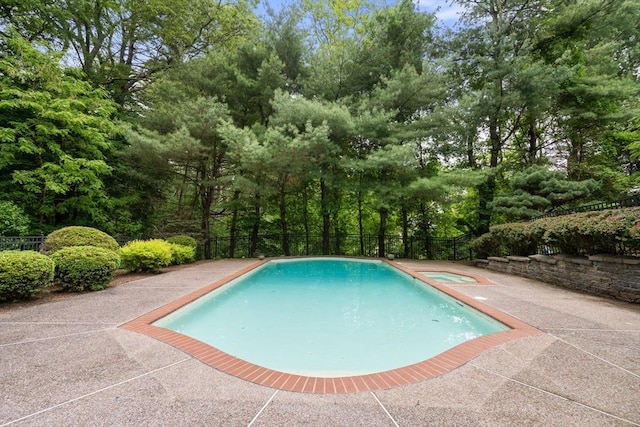 7 Cider Hill Ln, Sherborn, MA 01770 - view of pool with a patio, a pool with connected hot tub, and view of wooded area