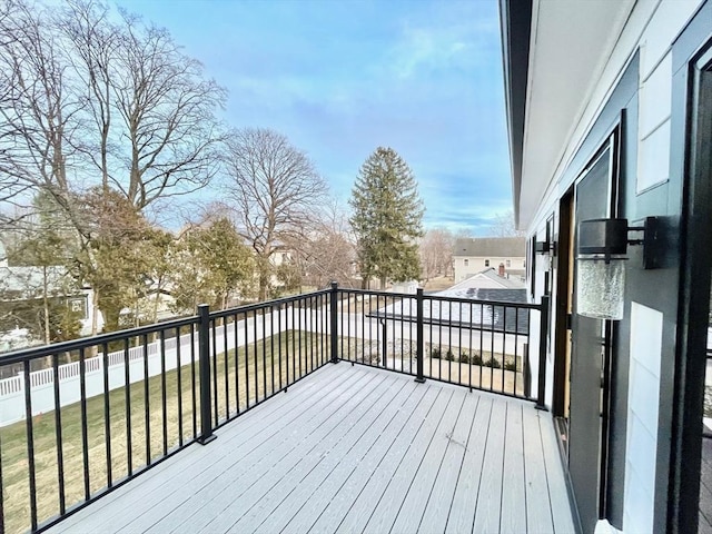 wooden deck featuring a lawn