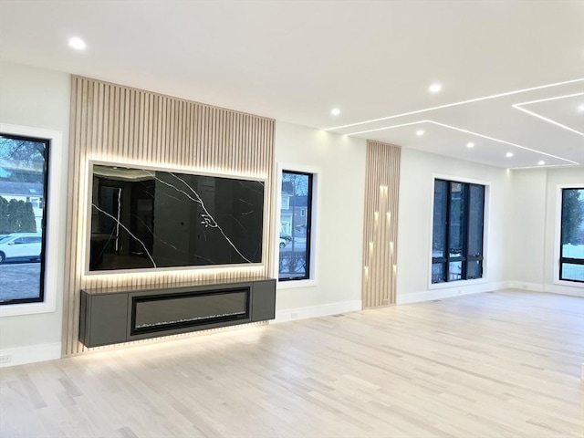 unfurnished living room with light hardwood / wood-style flooring