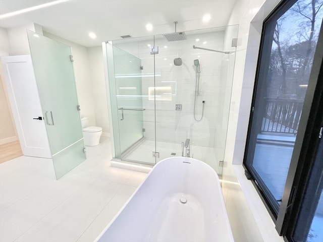 bathroom featuring toilet, tile patterned flooring, and independent shower and bath