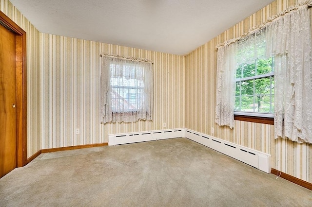 unfurnished room featuring wallpapered walls, carpet, and baseboards