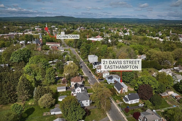aerial overview of property's location with a forest and nearby suburban area