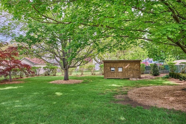 view of yard featuring a storage shed and an outbuilding