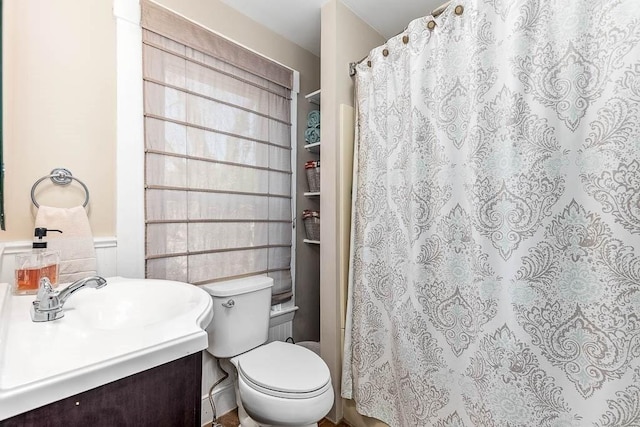 bathroom with vanity, toilet, and a shower with curtain