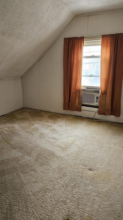 21 Morey St, Attleboro, MA 02703 - bonus room featuring a textured ceiling, vaulted ceiling, and carpet floors