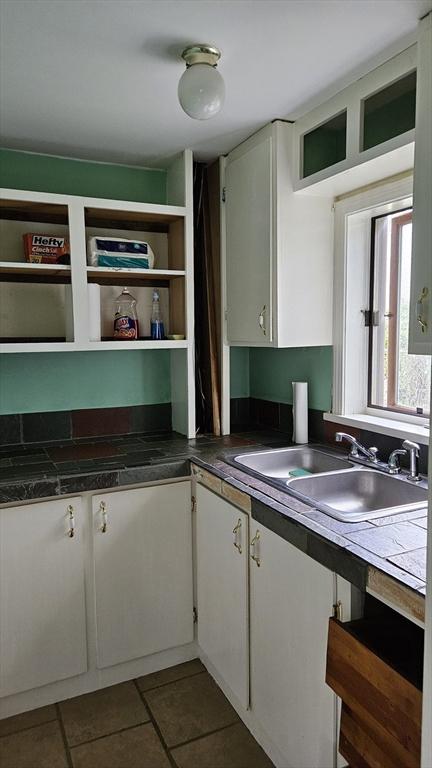 21 Morey St, Attleboro, MA 02703 - kitchen featuring a sink, open shelves, white cabinets, and dark countertops
