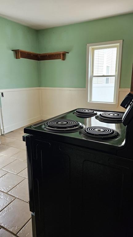 21 Morey St, Attleboro, MA 02703 - kitchen view of black electric range oven and a wainscoted wall