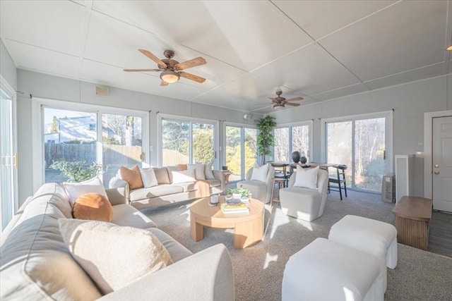 sunroom / solarium featuring plenty of natural light and ceiling fan