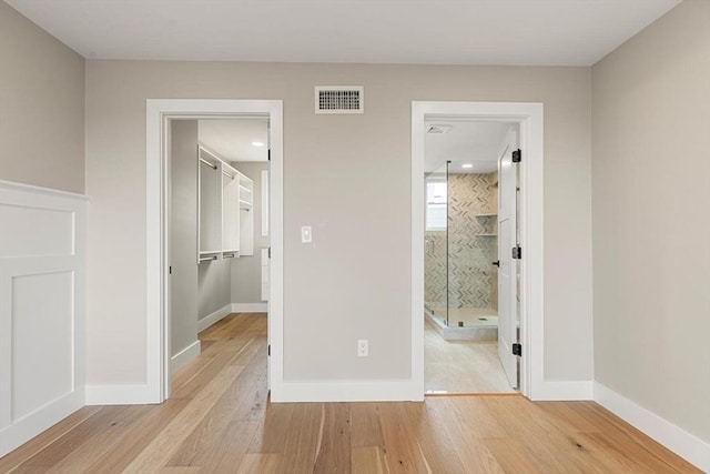 308 Newton St Unit 2, Waltham, MA 02453 - unfurnished bedroom featuring hardwood / wood-style flooring, a spacious closet, and baseboards