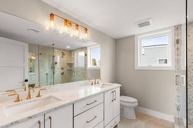 308 Newton St Unit 2, Waltham, MA 02453 - full bath featuring toilet, a marble finish shower, double vanity, and baseboards