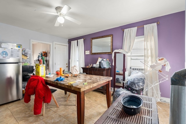 dining space featuring light tile patterned floors and ceiling fan