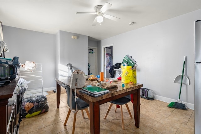 dining area with ceiling fan and light tile patterned floors