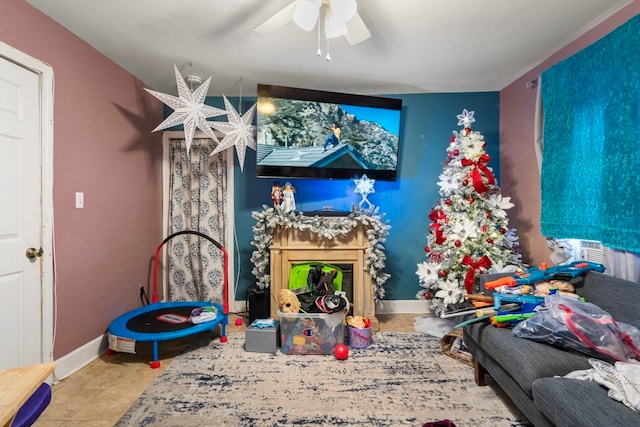 recreation room with ceiling fan and light tile patterned floors