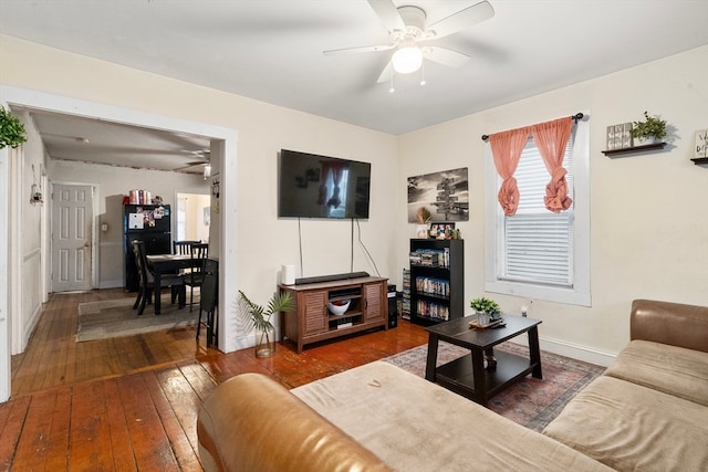 living room with ceiling fan and dark hardwood / wood-style floors