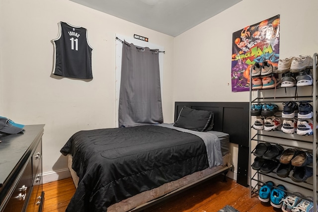 bedroom with dark hardwood / wood-style floors