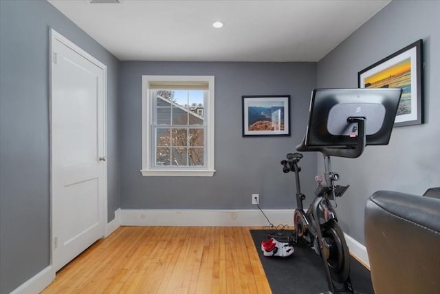 exercise area with light wood-type flooring and baseboards