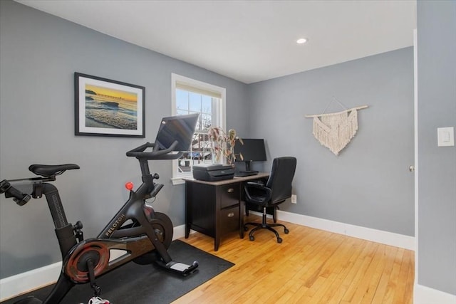 exercise room featuring hardwood / wood-style floors and baseboards