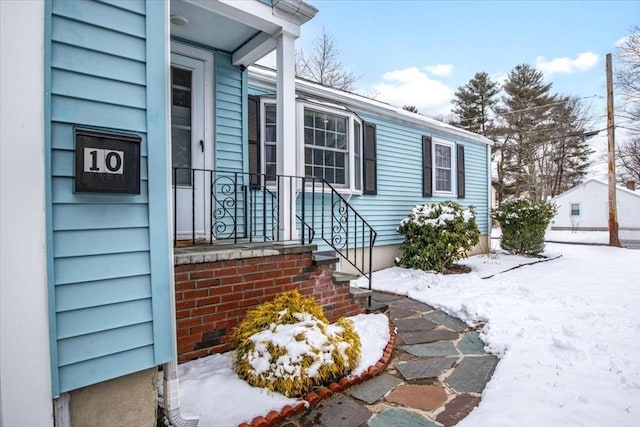 view of snow covered property entrance