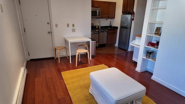 kitchen featuring a baseboard heating unit, open shelves, appliances with stainless steel finishes, and dark wood-style floors
