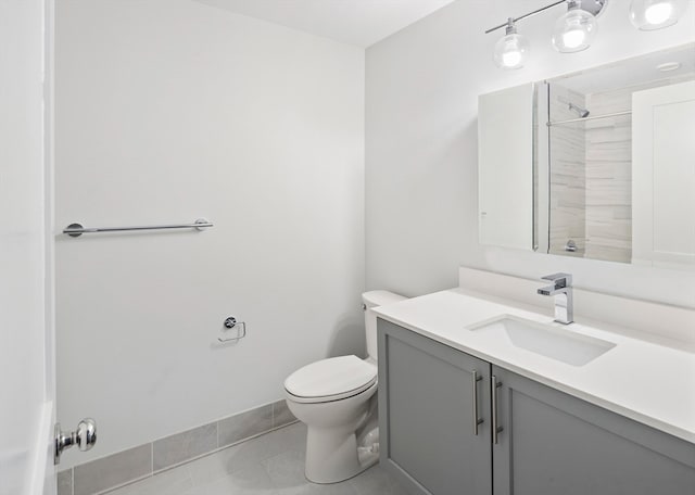 bathroom featuring tile patterned floors, a shower, vanity, and toilet