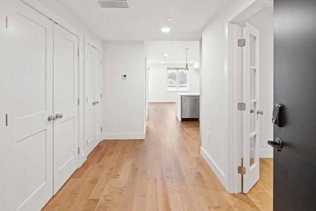 corridor with light hardwood / wood-style flooring