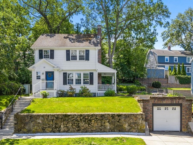 20 Humphrey St, Wakefield, MA 01880 - colonial inspired home featuring a chimney, a front yard, and driveway