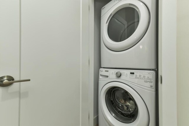 washroom featuring laundry area and stacked washer / dryer