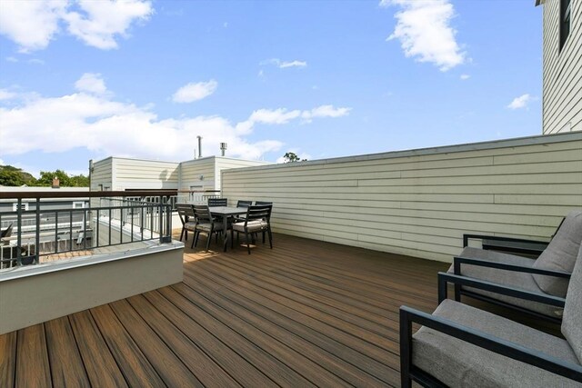 wooden deck featuring outdoor dining area