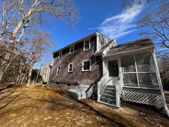 rear view of property with a sunroom