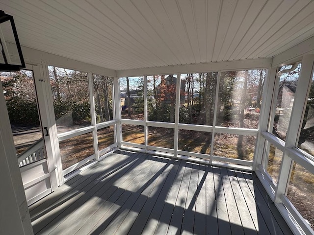 unfurnished sunroom with wood ceiling