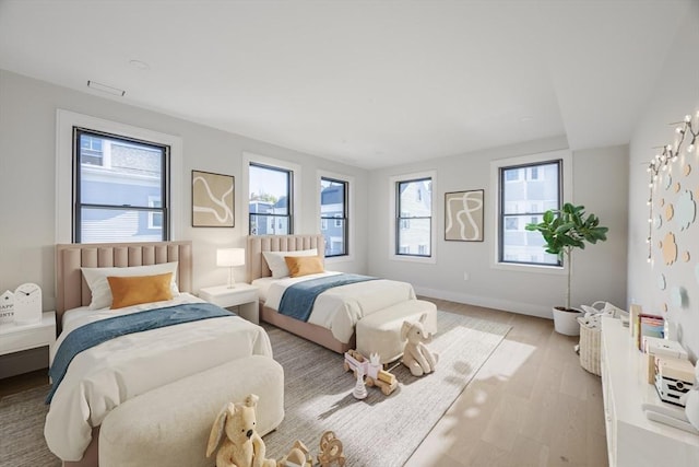 bedroom featuring light wood-style floors and baseboards