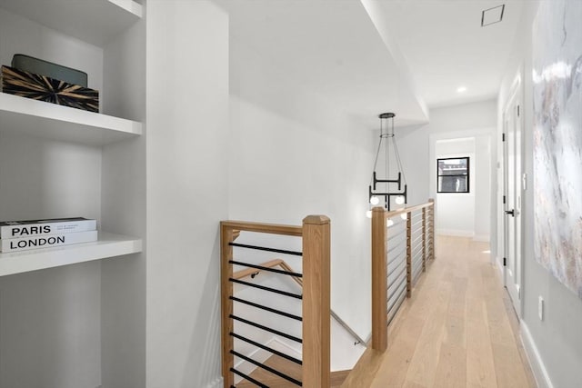 hall featuring baseboards, recessed lighting, an upstairs landing, and light wood-style floors