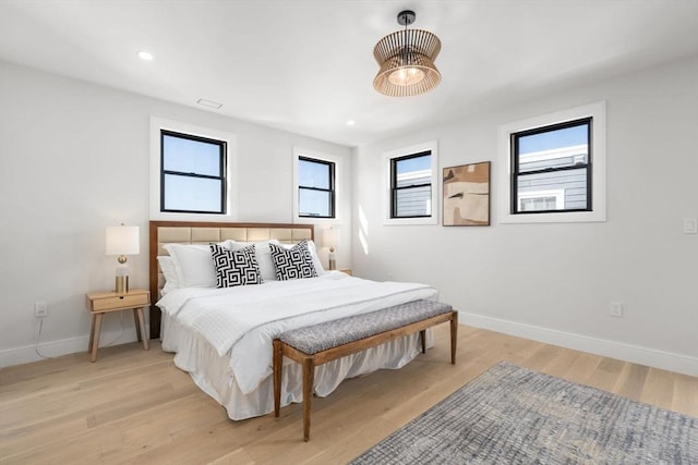 bedroom featuring light wood-style flooring, baseboards, and recessed lighting