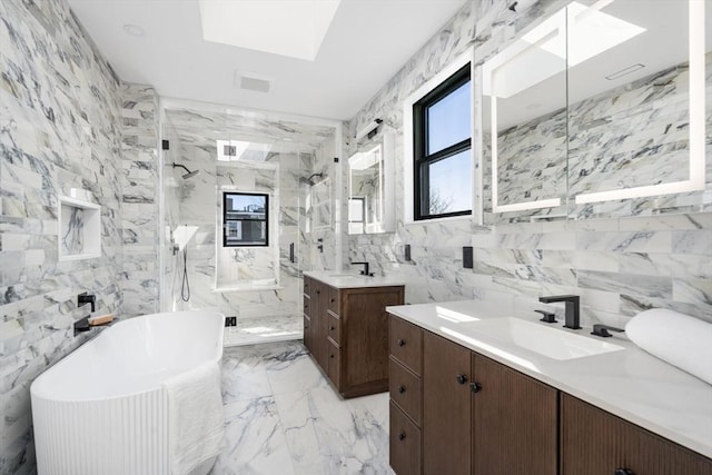 full bathroom with marble finish floor, a skylight, a sink, and a marble finish shower