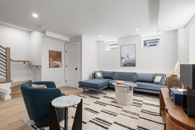 living area featuring light wood-style floors, stairs, and recessed lighting