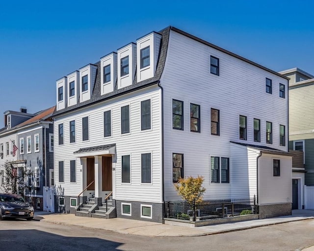 townhome / multi-family property featuring entry steps and a residential view