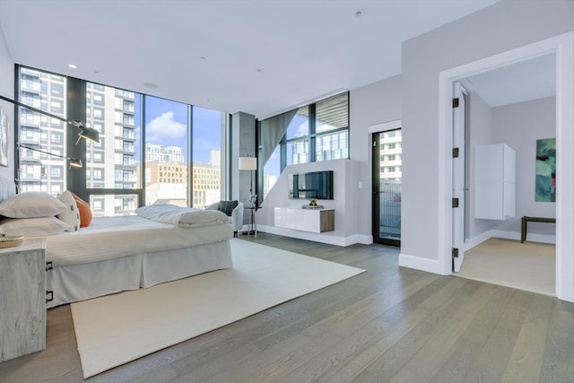 bedroom featuring baseboards and wood finished floors