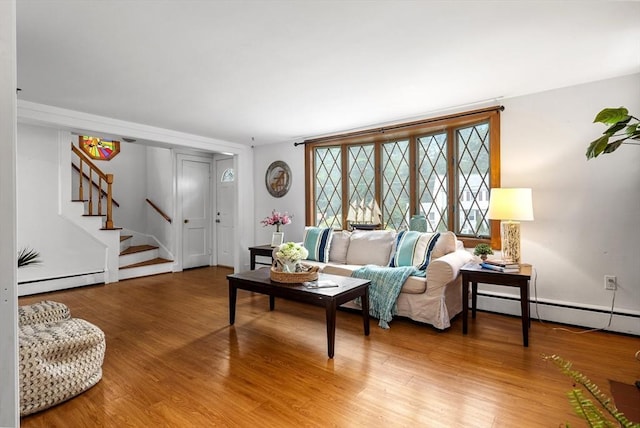 41 Sherrick Ave, Holbrook, MA 02342 - living area with a baseboard heating unit, stairway, and light wood-style floors