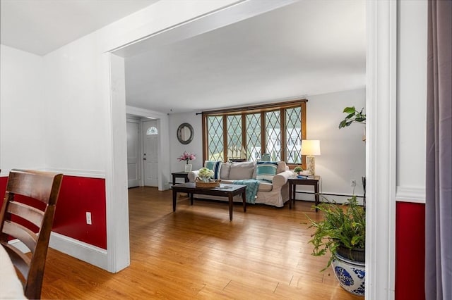 41 Sherrick Ave, Holbrook, MA 02342 - living area featuring light wood-style flooring and a baseboard radiator