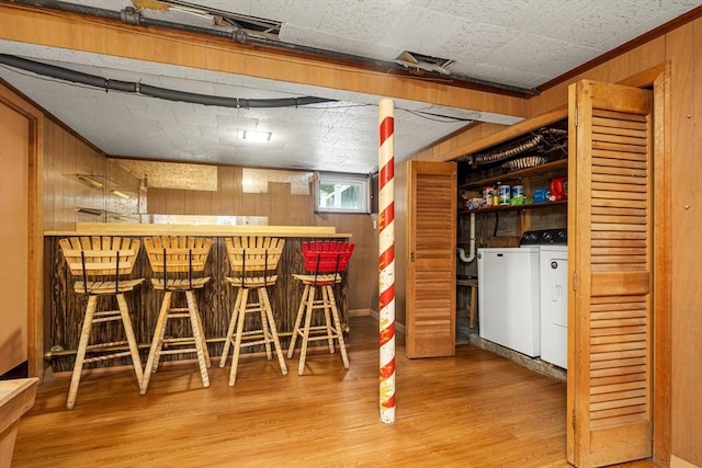 41 Sherrick Ave, Holbrook, MA 02342 - indoor dry bar featuring washing machine and dryer, wood walls, and wood finished floors