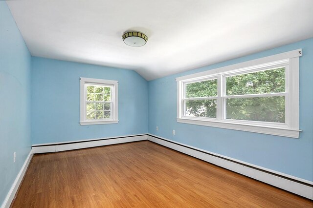 41 Sherrick Ave, Holbrook, MA 02342 - spare room with baseboard heating, wood finished floors, and vaulted ceiling