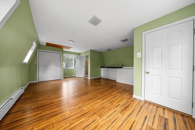 41 Sherrick Ave, Holbrook, MA 02342 - unfurnished living room with a baseboard radiator and wood finished floors