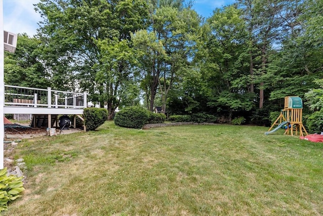 41 Sherrick Ave, Holbrook, MA 02342 - view of grassy yard with a playground and a wooden deck