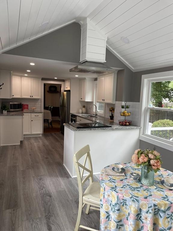 41 Sherrick Ave, Holbrook, MA 02342 - kitchen with stainless steel microwave, vaulted ceiling, freestanding refrigerator, wooden ceiling, and dark wood finished floors