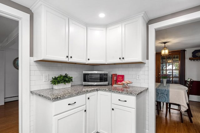 41 Sherrick Ave, Holbrook, MA 02342 - kitchen with stainless steel microwave, dark wood-style flooring, white cabinets, and recessed lighting