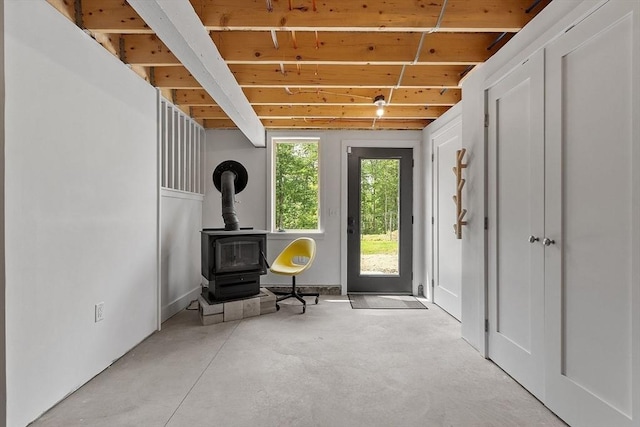 17 Hastings Rd, Ashburnham, MA 01430 - entryway featuring a wood stove, a wood ceiling with exposed beams, and concrete flooring
