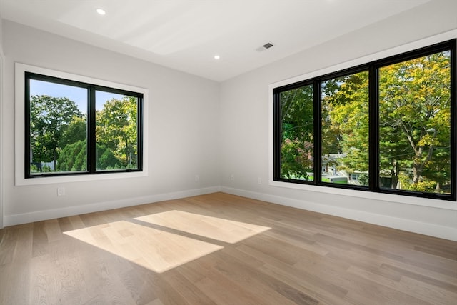 unfurnished room with light wood-type flooring